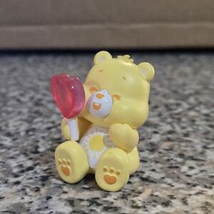 🍒🍒 Care Bears: Funshine Bear Figurine with Red Heart Lollipop
